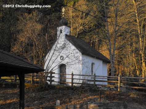 Little forest chapel in the Alps