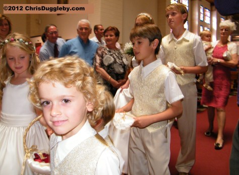 The seven bridesmaids and pageboys escort the Bride to the altar