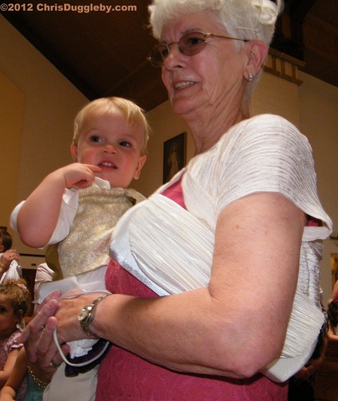 Youngest pageboy Adam gets some support from his English grandmother