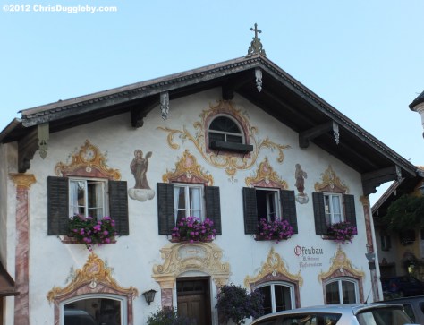 Next to the church another ornate Neubeuern building in bloom Next to the church another ornate Neubeuern building in bloom