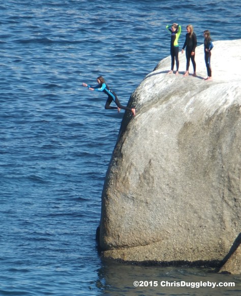 3 Four Cape Town Girls in Wetsuits jumping off Sunset Rocks