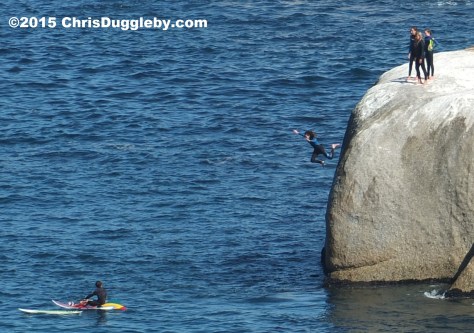 4 Four Cape Town Girls in Wetsuits jumping off Sunset Rocks